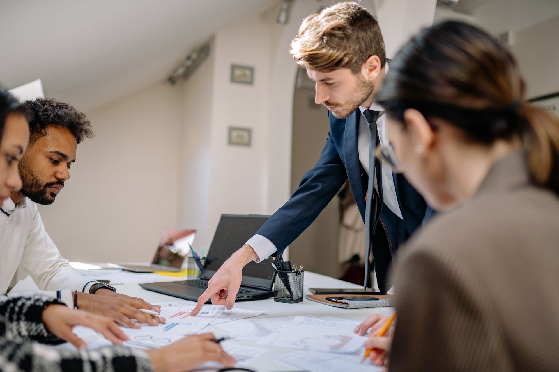A diverse team engaged in a business meeting, fostering collaboration and teamwork in an office setting.